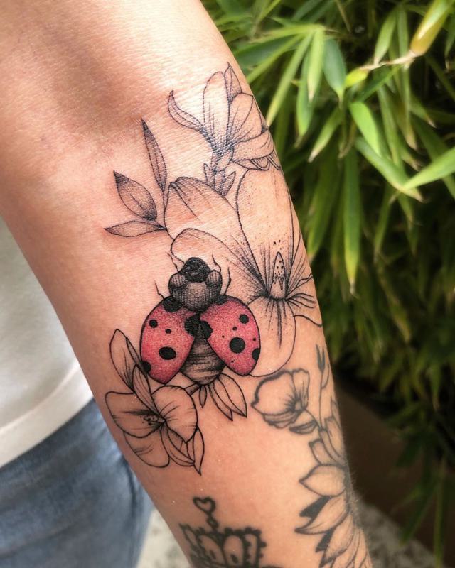 Realistic color flower and ladybug tattooladybug detail by Sorin Gabor  TattooNOW